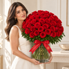 Model holding Classic MDF 75 red fresh roses with ruscus and branded red ribbon