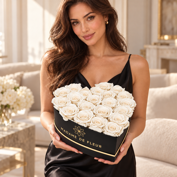 Model holding the Large Black Heart Box with white preserved roses — approved larger-scale model photo