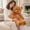Model holding a large caramel plush teddy bear
