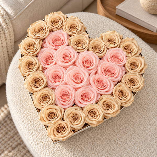 XL heart box with baby pink preserved roses beside champagne, lifestyle view