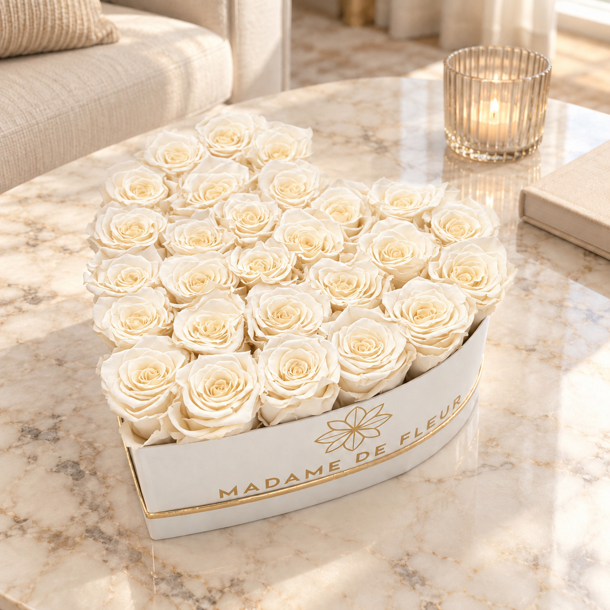 Large white heart box with ivory preserved roses on a marble coffee table